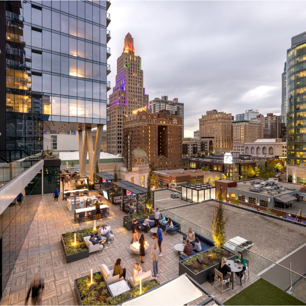 The outdoor amenity terrace at Three Light Luxury Apartments with views of the city.