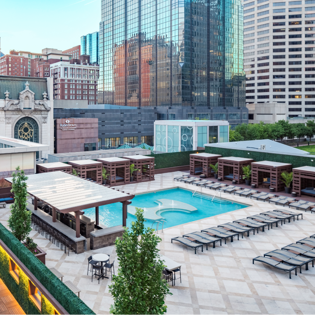 An aerial shot of the pool at One Light Luxury Apartments with cabanas.