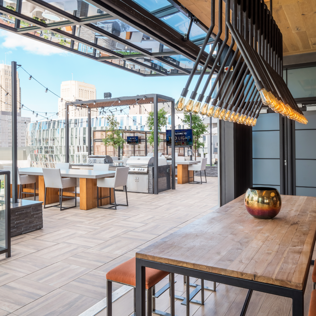 The indoor outdoor space at Two Light Luxury Apartments. Featuring seating and outdoor grills.